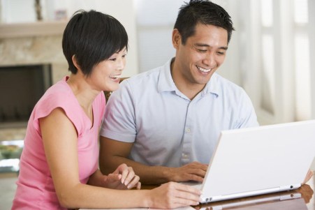 asian-couple-on-laptop-8-Most-Valuable-Tips-from-a-Renovation-Contractor